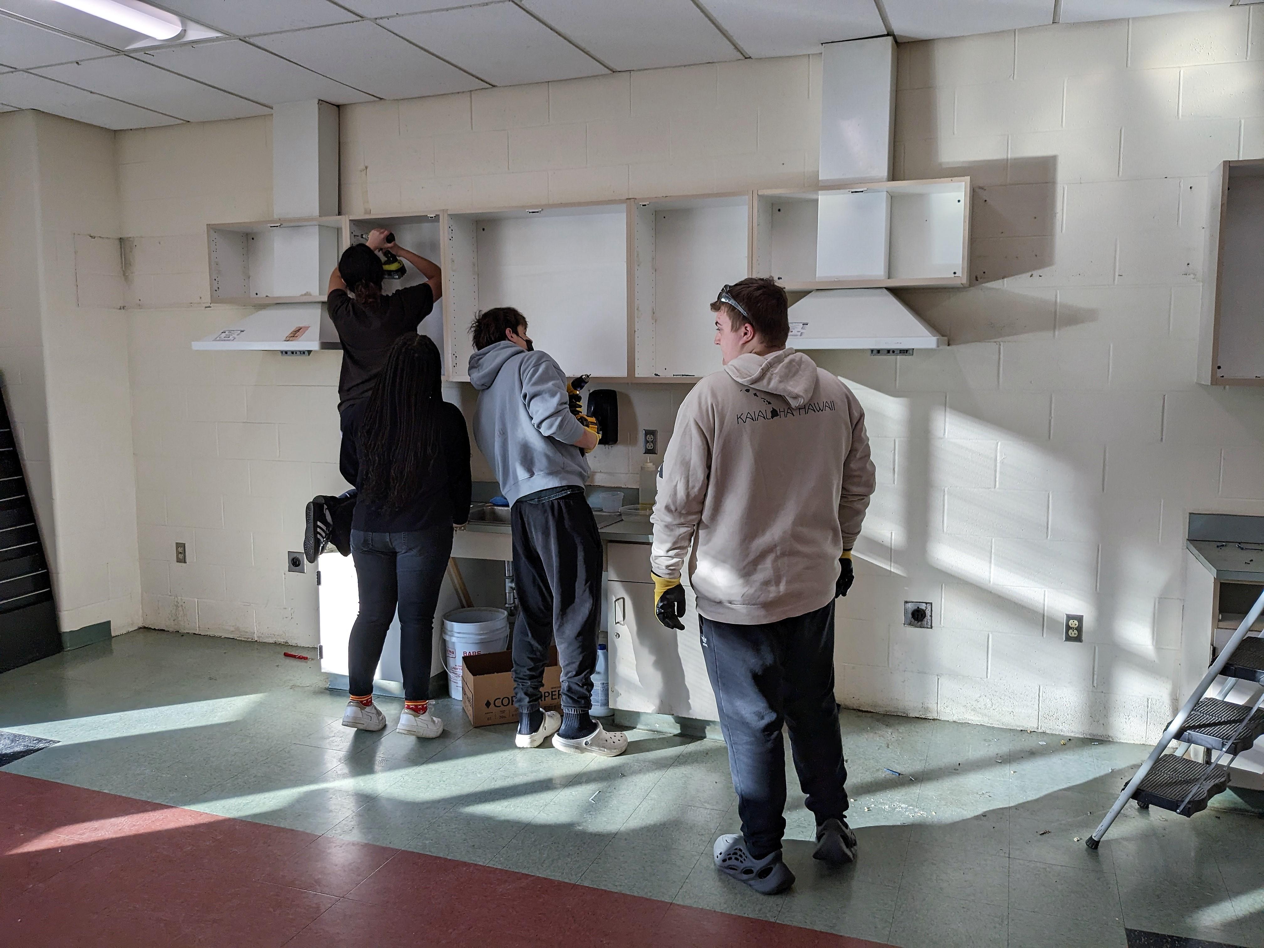 woodland students taking apart cabinets